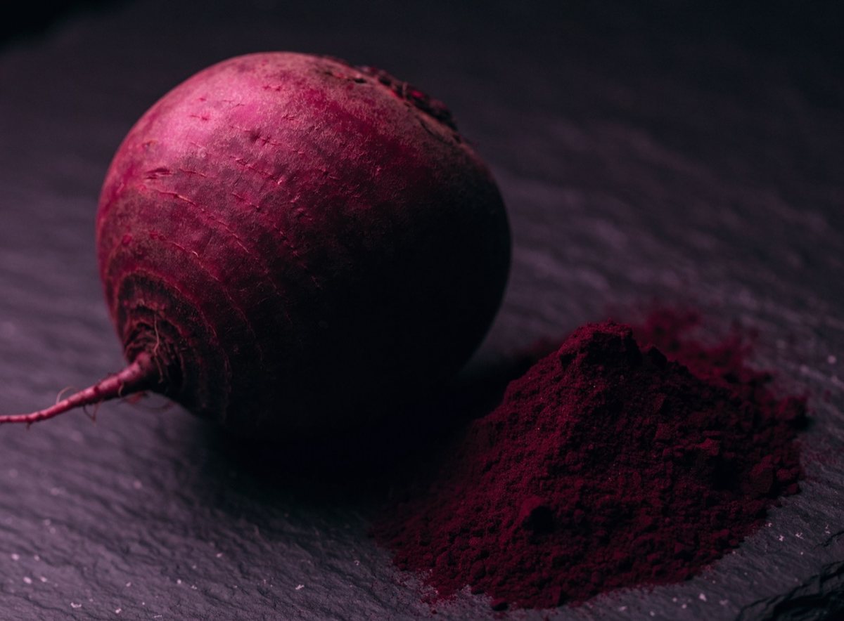 Raw beetroot next to finely ground beetroot powder.